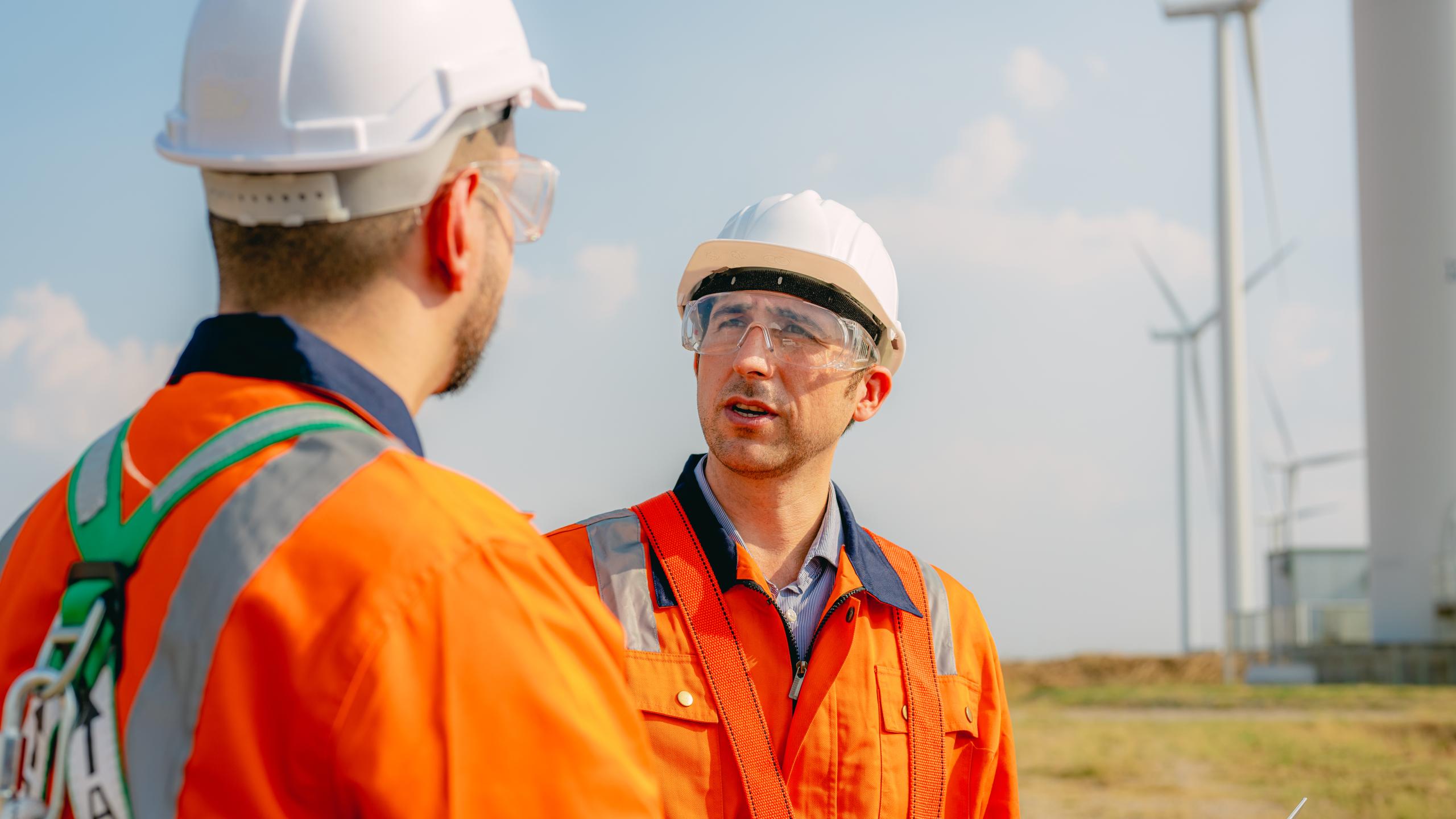 professional-engineer-technician-working-outdoor-wind-turbine-field-(1)